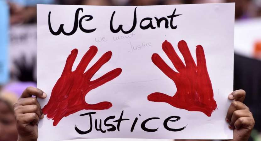 People protest over crimes against women, near Rajghat in New Delhi. A minor girl’s parents allegedly accepted a bribe of Rs 5 lakh to compel the rape victim to change her statement in court. People protest over crimes against women, near Rajghat in New Delhi. A minor girl’s parents allegedly accepted a bribe of Rs 5 lakh to compel the rape victim to change her statement in court.